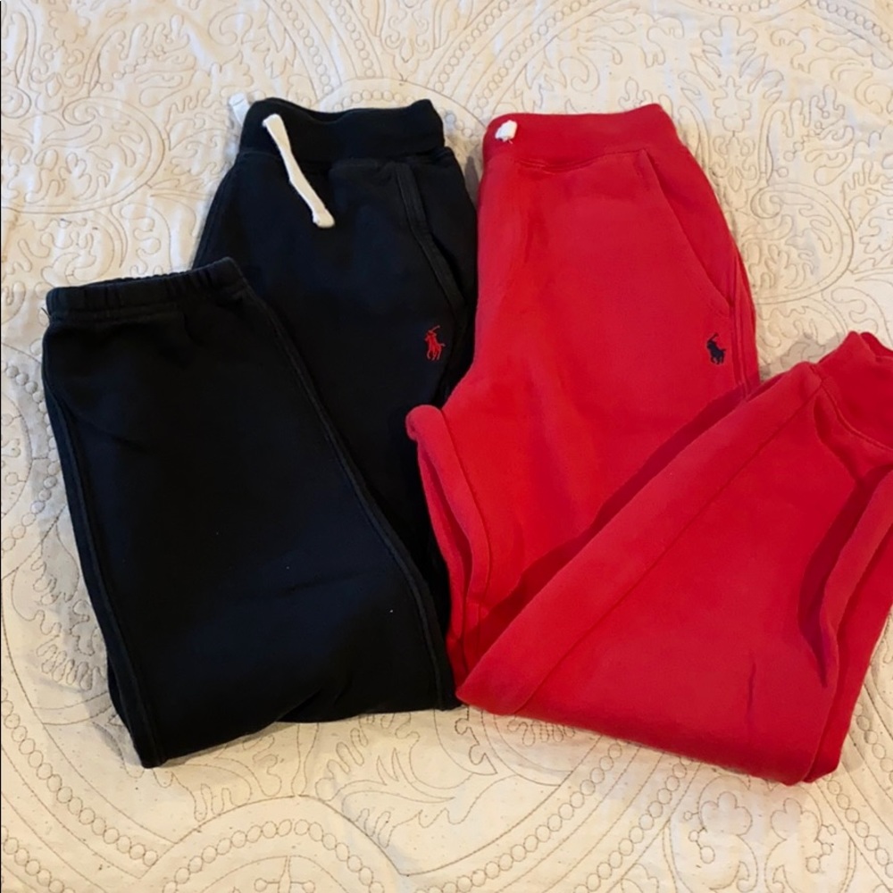 Two pair of jogging pants. One black one red